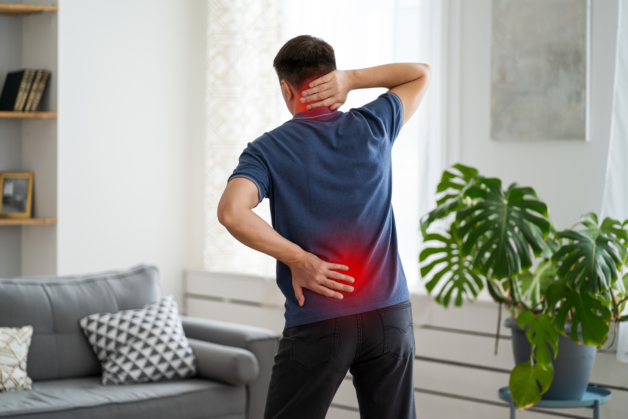 Back pain, man with backache at home man with neck and back pain